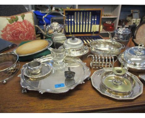 A selection of silver and silver late to include a silver tea strainer, a circular silver plated tray on ball and claw feet, 