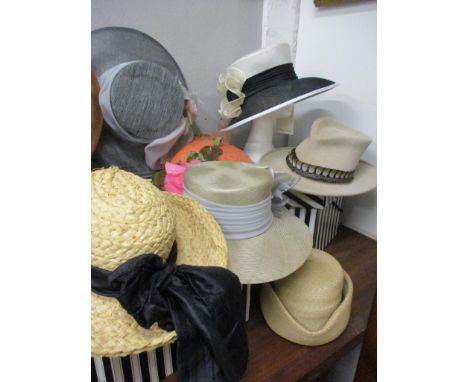 A Philip Treacy velour light tan hat with feather band, a black natural fibre formal hat designed by Graham Gwyther for Headw