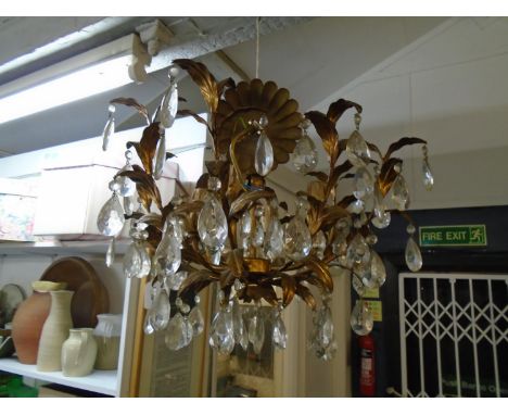 A gilt metal four branch chandelier of floral design with faceted glass drops, along with two reproduction art nouveau style 