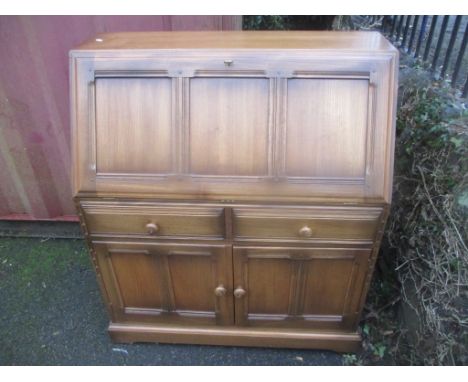An Ercol elm Golden Dawn connoisseur bureau having a fall flap above drawers and cupboards, 108.5h x 94.5cm w