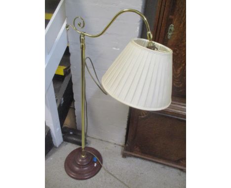 A brass standard lamp on a turned treen base