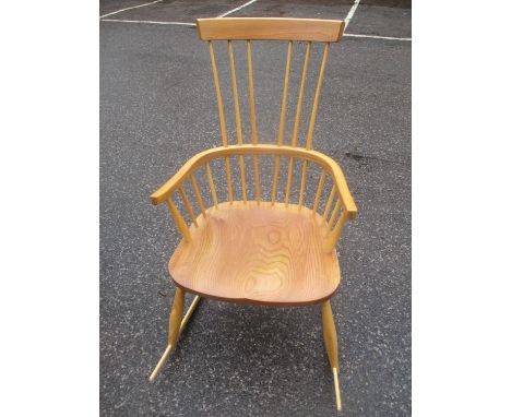 A possibly Ercol elm seated spindle back rocking chair