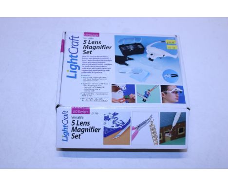 A boxed Light Craft five lens magnifier set 