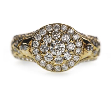 DIAMOND DRESS RING, the circular bezel set with round brilliant cut diamonds, with further diamonds to the shoulders, the dia