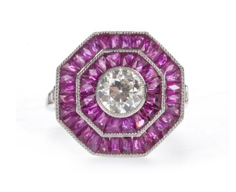 RUBY AND DIAMOND RING, the octagonal bezel set with a central old cut diamond of approximately 0.90 carats, within a double h