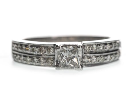 DIAMOND DRESS RING, set with a princess cut diamond of approximately 0.25 carats, with two rows of round brilliant cut diamon