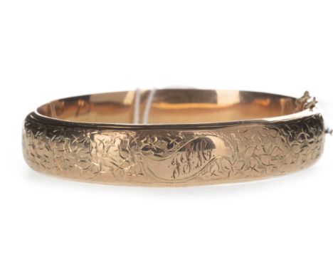 GOLD BANGLE, with engraved decoration to the front panel and engraved initials, in nine carat gold, 15.2g