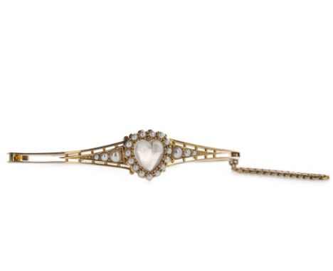HEART SHAPED GEM SET AND SEED PEARL BANGLE, set with a central cabochon heart shaped gem within a halo of seed pearls, flanke