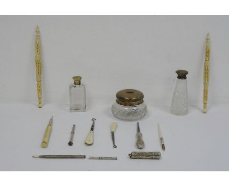 Silver lidded and glass dressing table bottle, a silver propelling pencil, a silver-handled manicure item, ivory and bone han