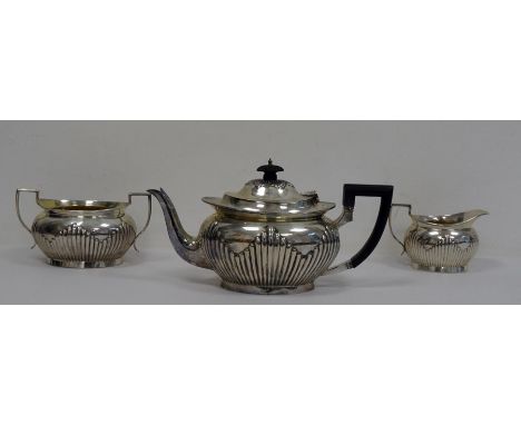 Mappin & Webb Victorian three-piece silver tea service, allover shaped semi-gadrooning, teapot with ebonised handle, two-hand