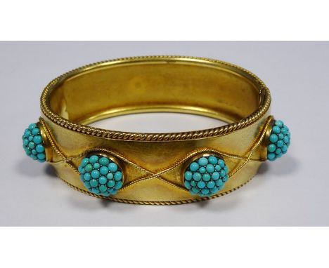 Victorian gold coloured metal hinged bangle having raised turquoise set circular balls within ropetwist borders, 48.6g in tot