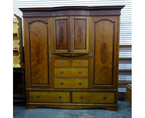 19th century wardrobe compactum with dentil cornice above two short bowed doors, above two short and two long drawers, flanke