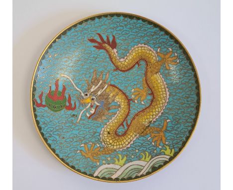 Chinese cloisonne saucer, decorated with a dragon chasing a flaming pearl, reserved on a blue ground, gilt cloud pattern, the