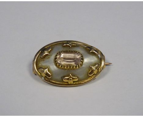 Victorian gold coloured and metal mounted mother of pearl and pink stone oval shaped brooch&nbsp;with relief decorationCondit