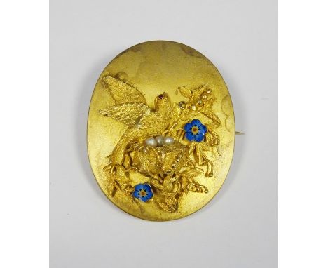 Victorian gold-coloured oval brooch/pendant with relief of bird and nest, with enamelled flowers and pearl eggs, photograph t