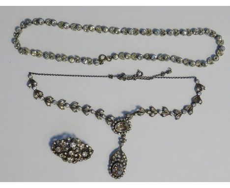 Silver and paste set necklace of stylised leaf pairs and set with two oval facet cut pendants, paste necklace in the form of 