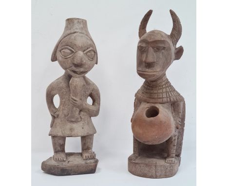 Carved African figure, possibly West African, horned with carved cloak and hole to stomach, 32cm high and another carved Afri
