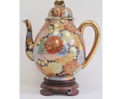 Early 20th century Japanese porcelain oviform teapot, cover and hardwood stand, gilt character mark to base, decorated in col