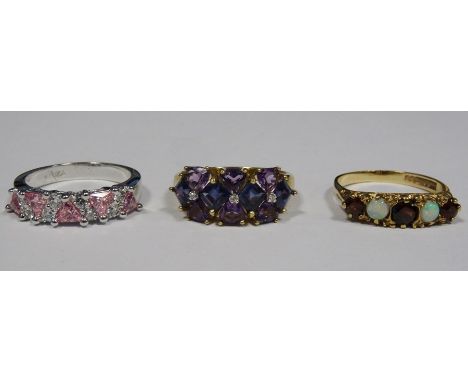 9ct gold, amethyst-coloured stone and diamond dress ring set three small diamonds surrounded by triangular purple stones, a 9