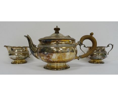 1940's silver teapot, matching milk jug and two-handled sugar bowl with wooden finial and handle, gadrooned border on circula