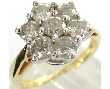 18ct gold flower head ring set with seven diamonds totalling 1ct, size J/K, 3.95g. P&amp;P Group 1 (£14+VAT for the first lot