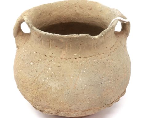 A Neolithic period urn or vessel, unusually decorated with incised decoration and unpainted, having twin handles, D: 12 cm, H