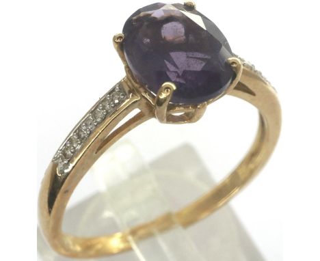 9ct gold ring set with central amethyst and diamond set shoulders, size T, 2.5g, shank misshapen. P&amp;P Group 1 (£14+VAT fo