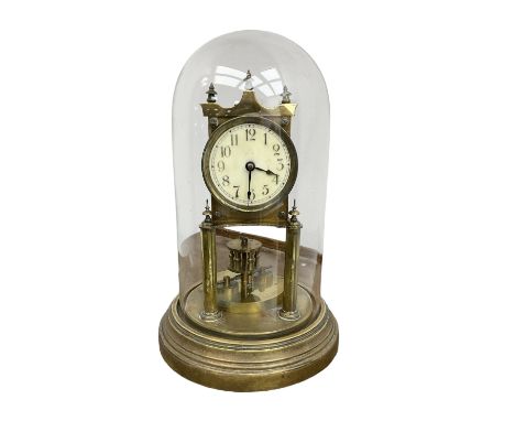 German - Gustav Becker BHA torsion clock c1900 on a circular stepped brass base with a glass dome, skeleton movement raised o