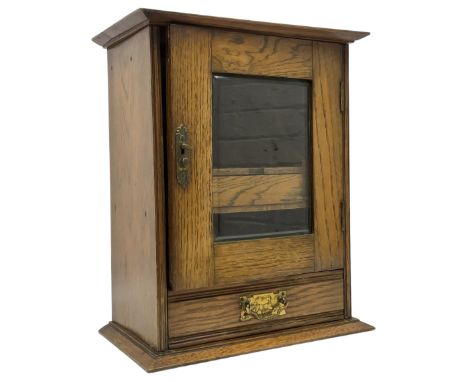 Early 20th oak smokers cabinet with the single glazed door to fitted interior having a single draw and pipe rack, H40cm pipe 