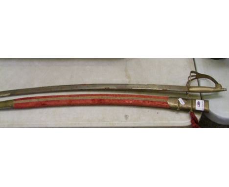 A vintage 'Made in India' sword: with brass horses head handle and red velvet covered scabbard. 