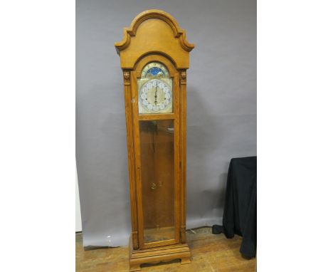 AN OAK LONGCASE CLOCK, the rectangular arched hood containing a brass and silvered dial with phases of the moon inscribed Rid