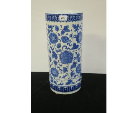 A MODERN ORIENTAL STYLE BLUE AND WHITE GLAZED STICK STAND, of circular form decorated with foliate motifs,46cms x 22cms.