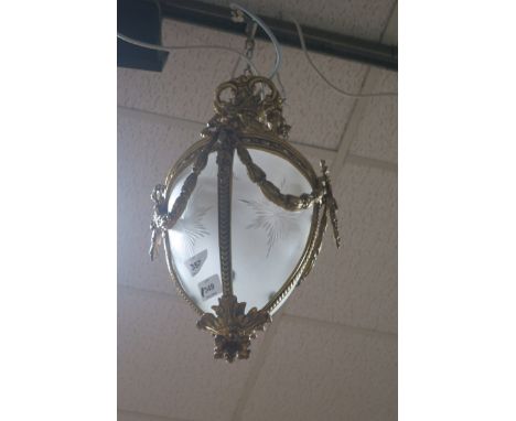 A CONTINENTAL GILT BRASS FROSTED AND ENGRAVED GLASS CENTRE LIGHT, hung with ribbon tied swags.