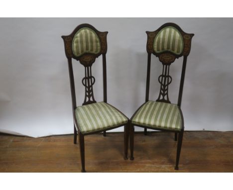 A PAIR OF EARLY 20TH CENTURY MAHOGANY AND MARQUETRY INLAID TALL BACK CHAIRS the shaped top with an outset upholstered panel f