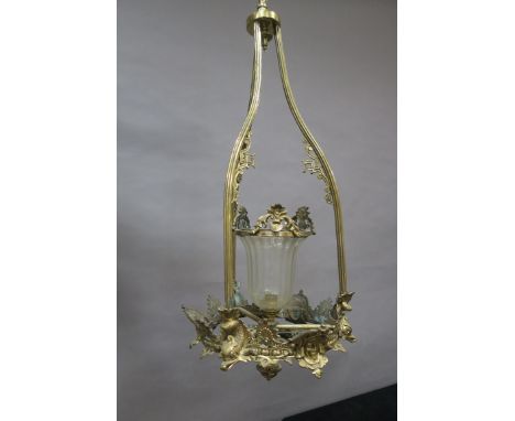A CONTINENTAL STYLE BRASS FRAMED CENTRE LIGHT, the openwork reeded tubular frame decorated with foliate motifs and centred by
