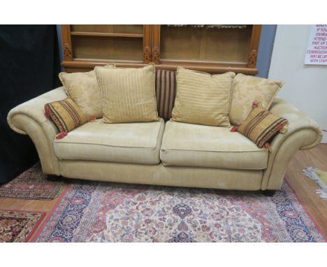 A MODERN GOLD VELVET UPHOLSTERED SCROLLED END THREE SEATER SOFA, with close upholstered back and seat, loose cushions and thr