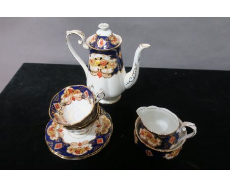 A ROYAL ALBERT  BONE CHINA TEASET (HEIRLOOM PATTERN), the white ground decorated with blue foliate filled borders with gilded