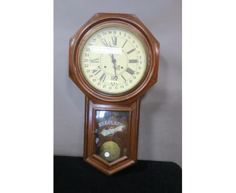AN AMERICAN REGULATOR WALL CLOCK, the octagonal case containing a white painted dial with roman numerals and signed Ansonia a