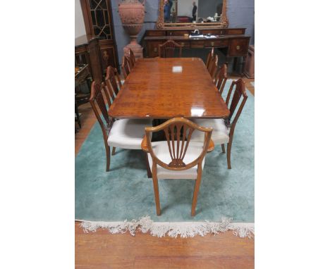 A REGENCY STYLE DINING ROOM SUITE, comprising of a burr-walnut veneered table of rectangular form, with crossbanded top round