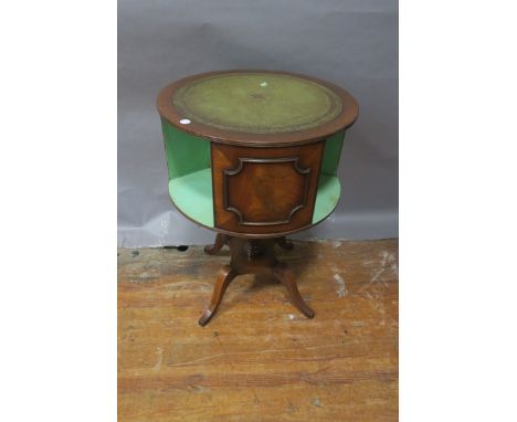 A GEORGIAN STYLE MAHOGANY AND LEATHER TOOLED CIRCULAR REVOLVING BOOKSTAND, the green leather tooled top above the panelled an