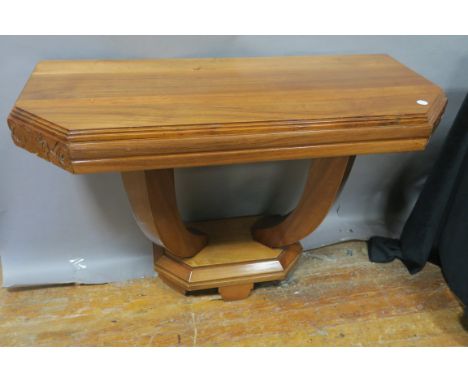 A PAIR OF ART DECO CONSOLE TABLES, each of rectangular outline with canted angles carved frieze on shaped supports and platfo