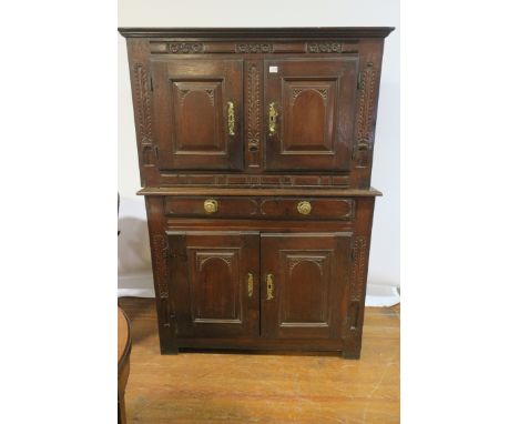 AN 18TH CENTURY OAK CARVED DRESSER the rectangular top with a pair of panelled doors above the outset base with one long draw