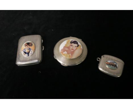 A SILVER ENGINE TURNED CIGARETTE CASE, TOGETHER WITH A SILVER ENGINE TURNED VESTA CASE, with enamelled inset depicting a cat 