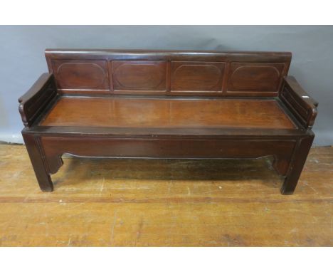 AN ORIENTAL STYLE CARVED WOOD BENCH, the rectangular panelled back with shaped  sides panelled seat above a shaped apron on s