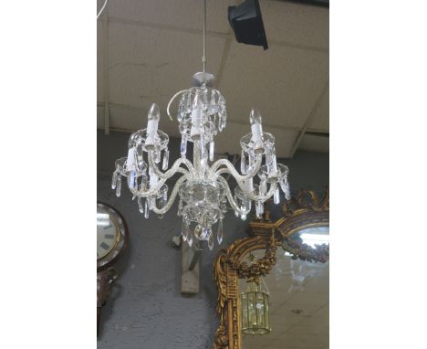 A CUT GLASS EIGHT LIGHT CHANDELIER, the foliate and diamond cut frame hung with spiral twist scrolled arms with foliate drip 