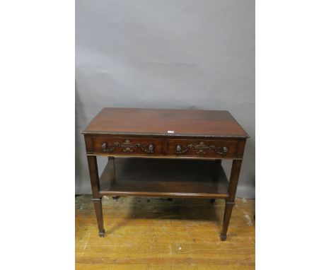 A GEORGIAN REVIVAL MAHOGANY FRAMED SIDE TABLE, the rectangular top with foliate carved rim above two frieze drawers, decorate