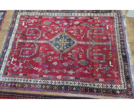 A FINE WOOL RUG, light pink ground with central geometric panels, conforming border 187cms x 138cms 