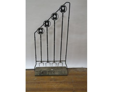 AN EARLY 20th CENTURY METAL FRAMED STANDING "TOASTER SET", the open tubular frame fitted with four double pronged forks, the 