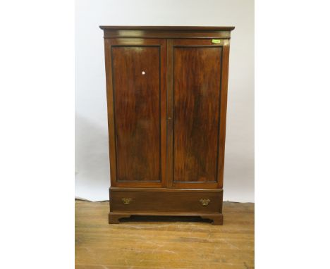 A 19TH CENTURY MAHOGANY TWO DOOR WARDROBE,  with moulded cornice, panel  doors containing hanging rails, with one frieze draw