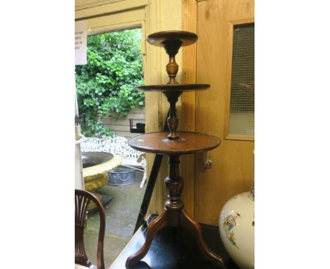 A MAHOGANY THREE TIER DUMB WAITER, each moulded shelf joined by baluster support.